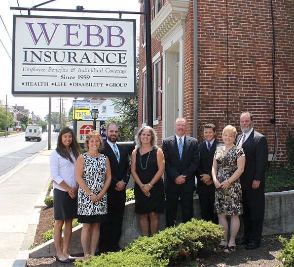 Webb Insurance team standing outside their building